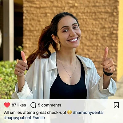 A happy, smiling patient standing outside the Pure Cypress Dentist clinic after a comfortable and successful dental visit